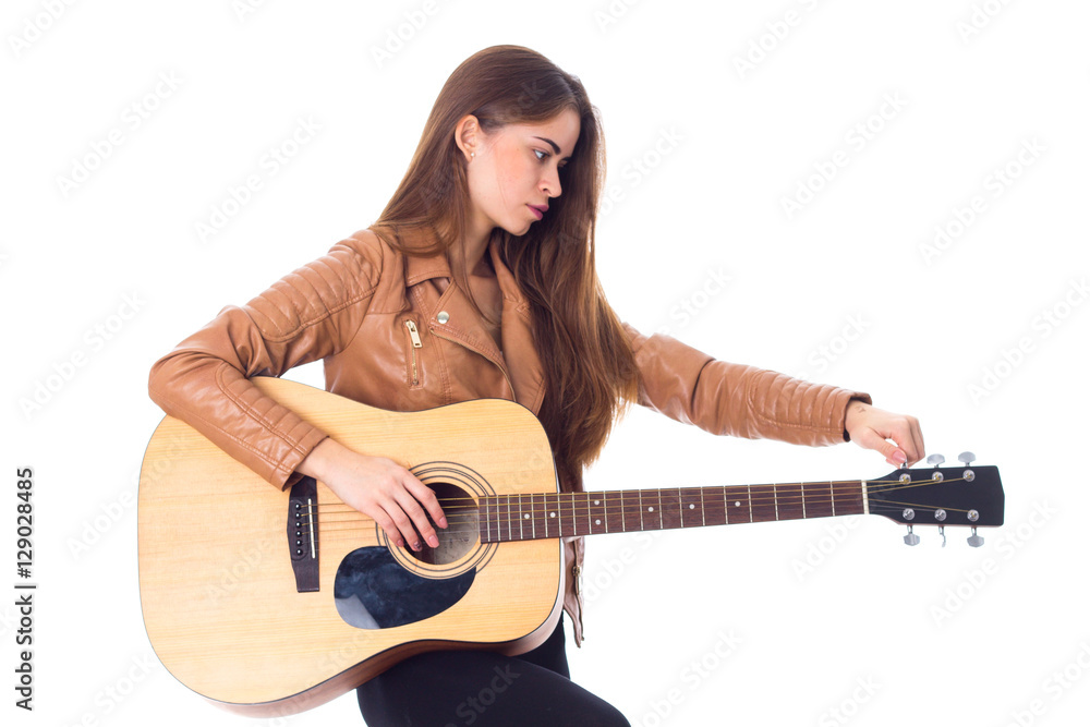 Young woman holding a guitar Young woman holding a guitar