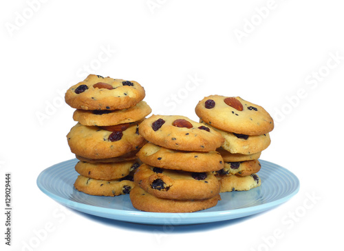 Close-up of almond raisin butter cookies piled up on a plate Isolated on White Background