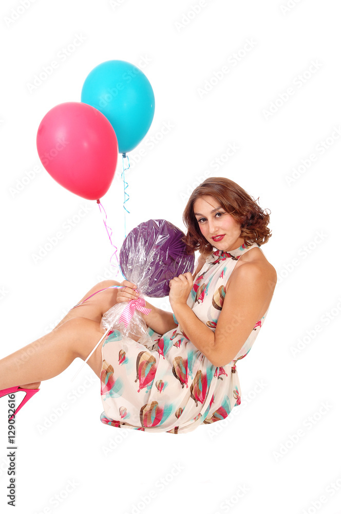 Woman sitting on floor with balloons. Woman sitting on floor with balloons.