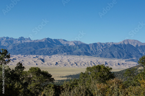Colorado sand dunes framed by trees and mountains