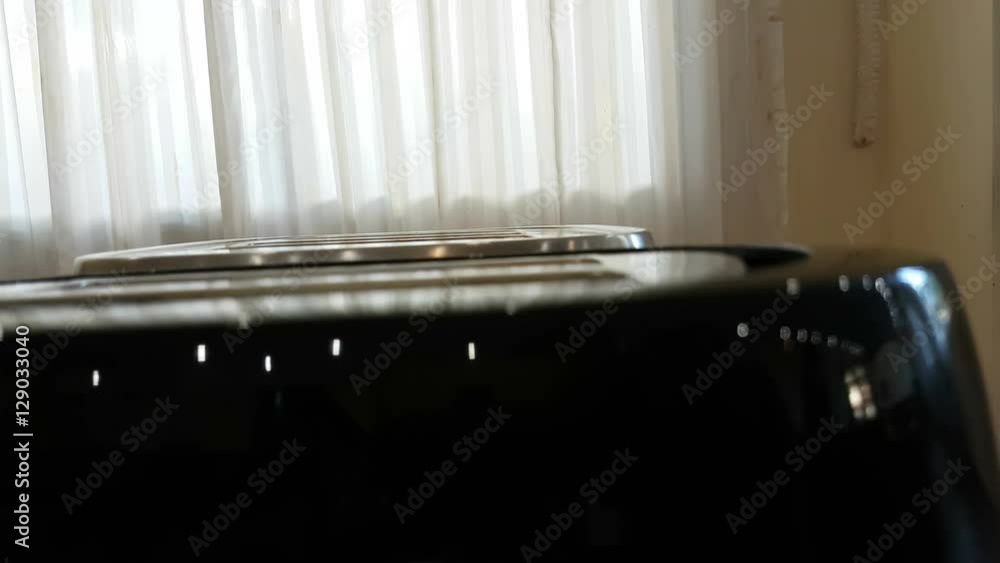 Roasted toast bread popping up from toaster machine in the room with curtain, 4K
Roasted toast bread popping up from toaster machine in the room with curtain, 4K