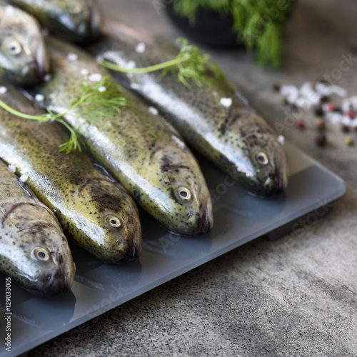 Raw trouts on gray board ready for cooking