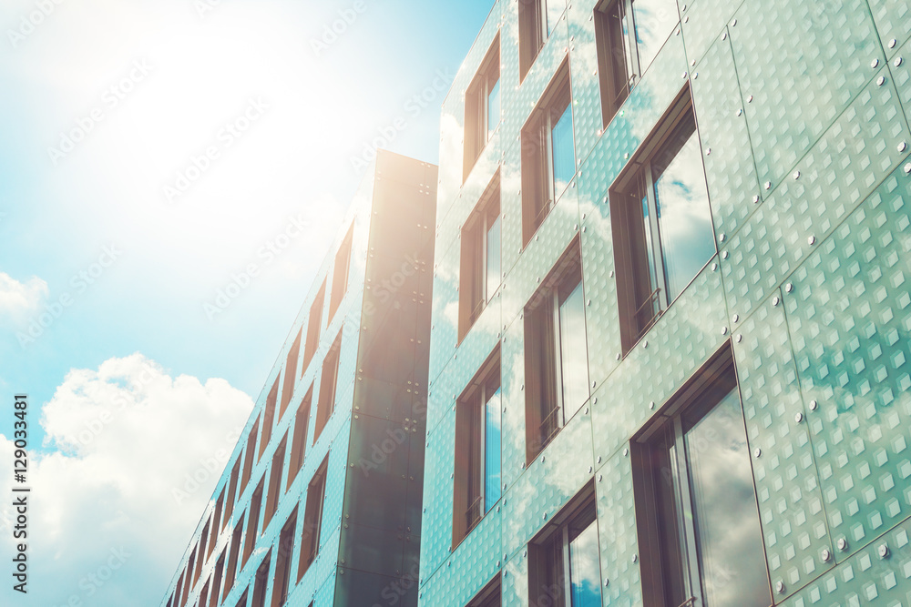 modern office facade with sun reflections in the blue windows modern office facade with sun reflections in the blue windows
