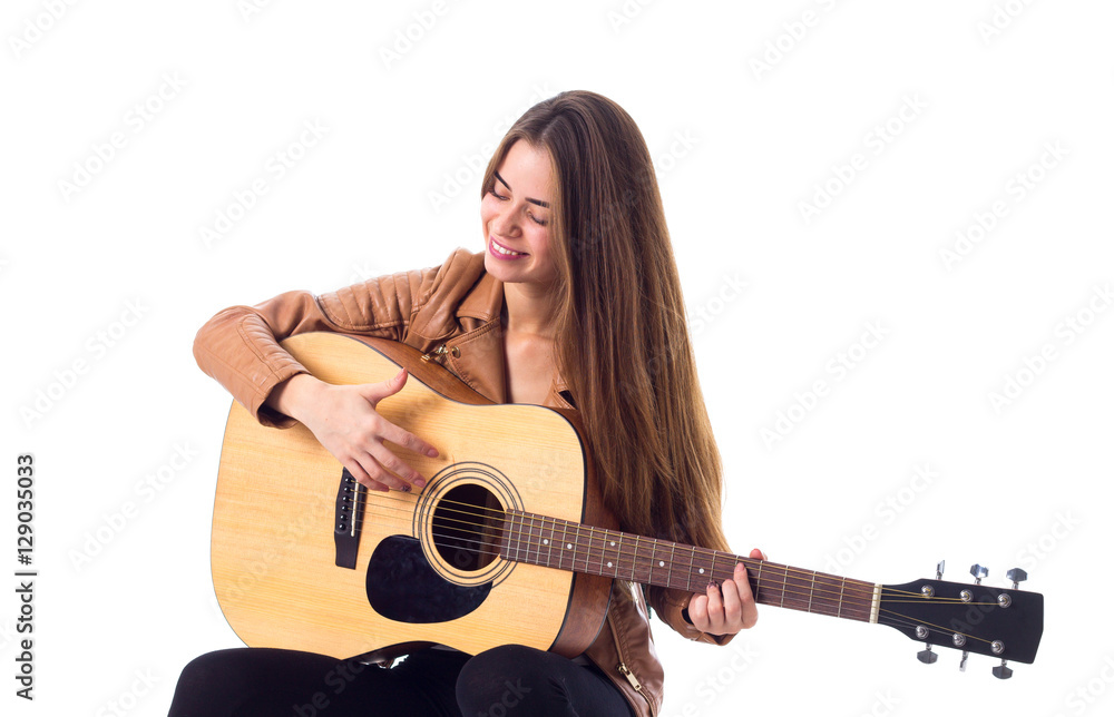 Young woman holding a guitar Young woman holding a guitar