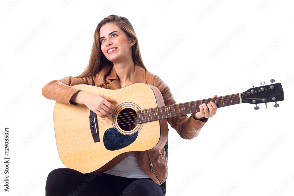 Young woman holding a guitar Young woman holding a guitar