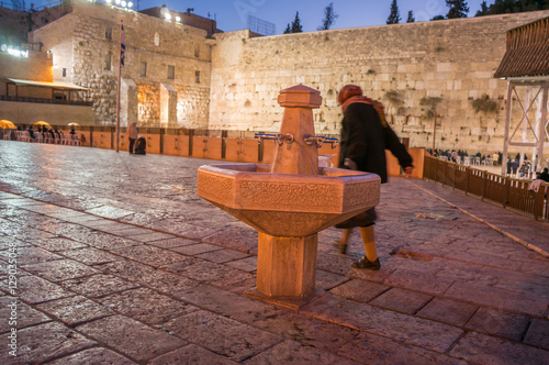 Old Lady approaches the Western Wall after washing her hand at the washing station in the Western Wall Plaza © david