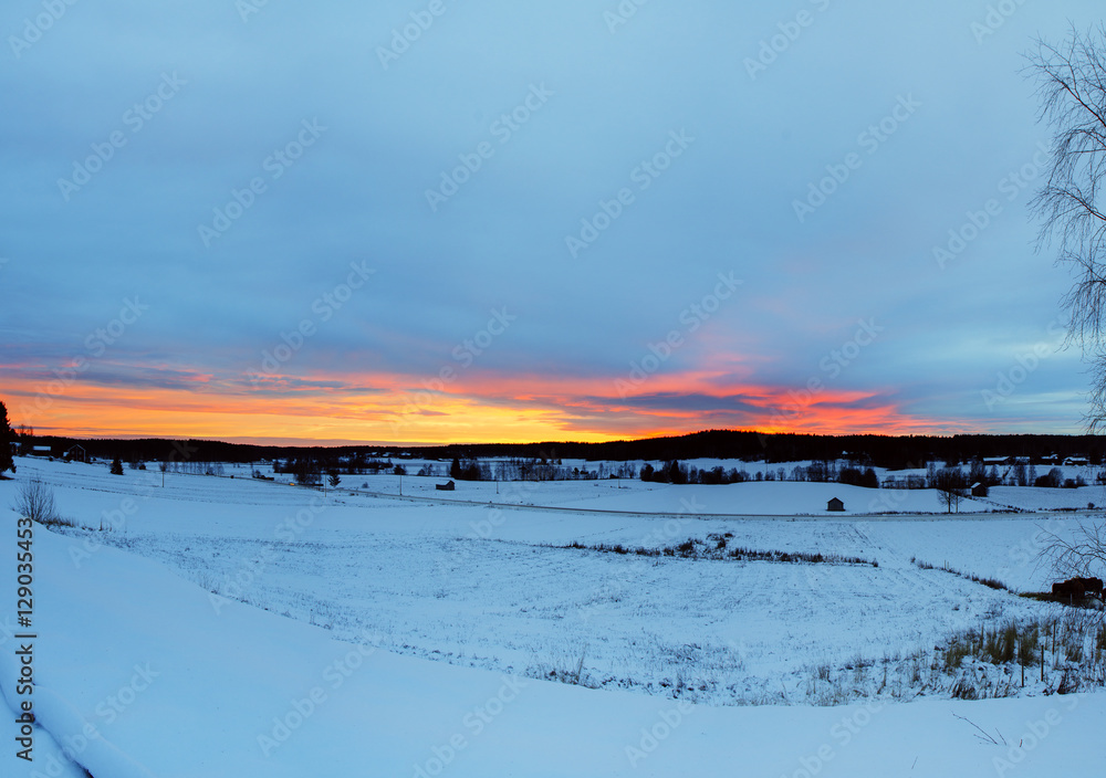 Winter sunset landscape with dramatic sky in Sweden, north scandinavian seasonal hipster background.