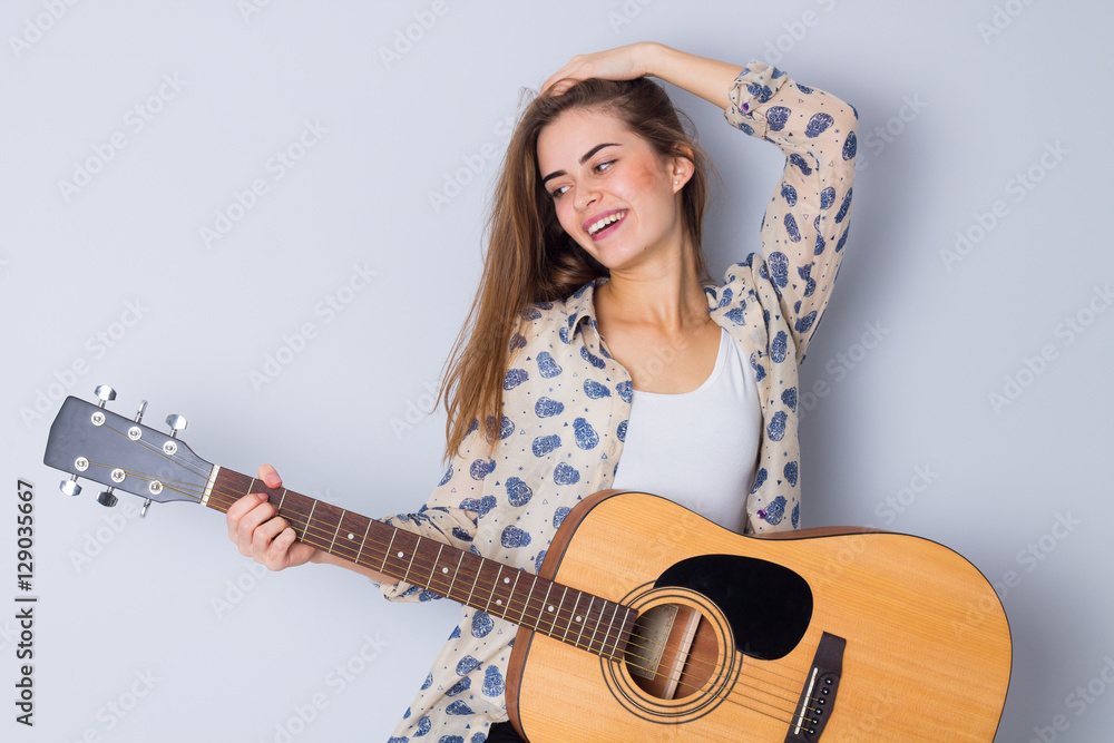 Fototapeta premium Young woman holding a guitar 