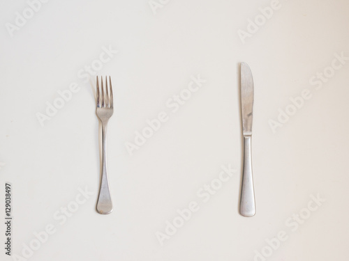 Food background - high angle view of fork and knife on white table