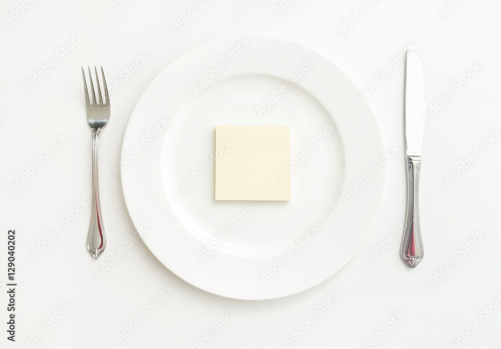Yellow piece of paper on plate on table Yellow piece of paper on plate on table