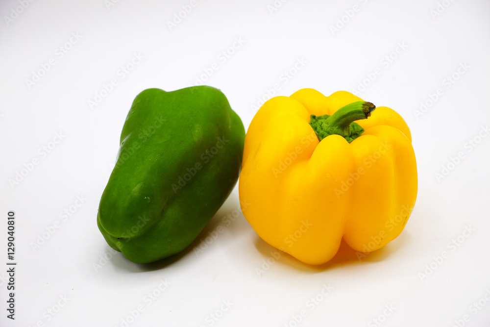 Green and yellow peppers on white background Green and yellow peppers on white background