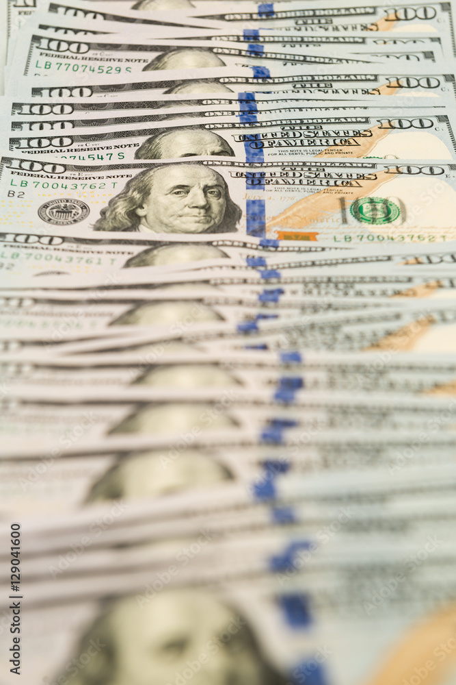 Many hundred dollar banknotes spread on surface Many hundred dollar banknotes spread on surface