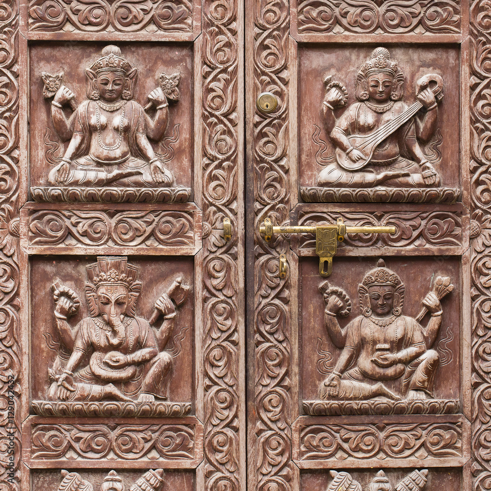 Detail wooden carved door in hindu temple, Kathmandu, Nepal background. Close up