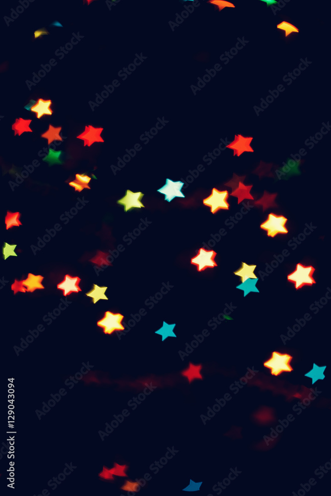 Christmas, New Year background with beautiful stars bokeh of colorful garland lights