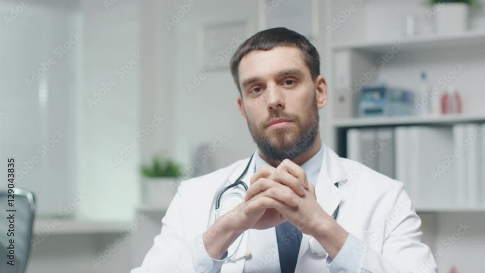 Male Doctor Speaks into the Camera While Sitting in His Office. Shot on RED Cinema Camera in 4K (UHD). Male Doctor Speaks into the Camera While Sitting in His Office. Shot on RED Cinema Camera in 4K (UHD).