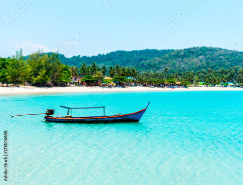 tilt shift of fishing boat in the blue sea at coast of Thailand