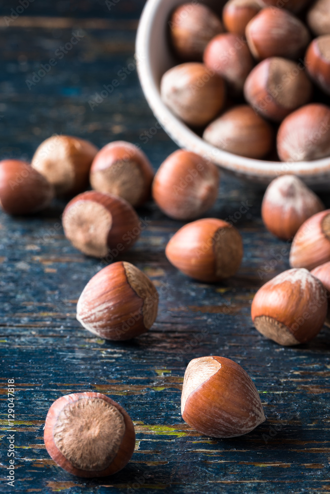 Obraz premium Hazelnuts Spilled from a Bowl