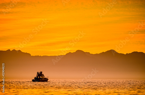 Silhouette of Speed boat in the ocean at sunset. Boating at sunset in Atlantic ocean, South Africa
