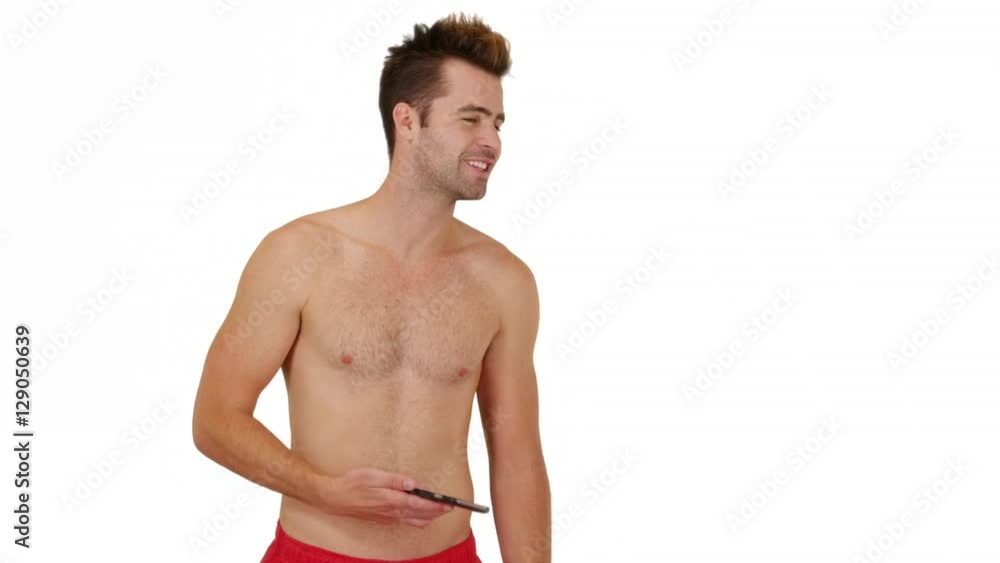 Happy man in swimsuit standing in front of white background with copy space Happy man in swimsuit standing in front of white background with copy space