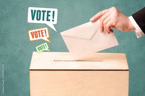 placing a voting slip into a ballot box