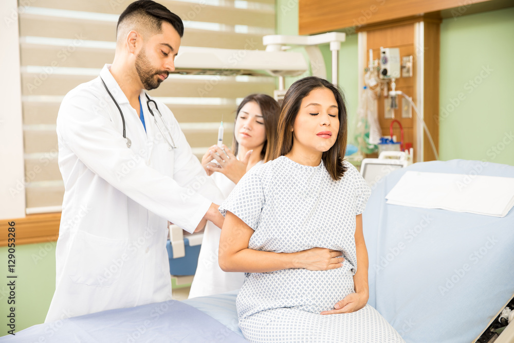 Pregnant woman getting a shot Pregnant woman getting a shot
