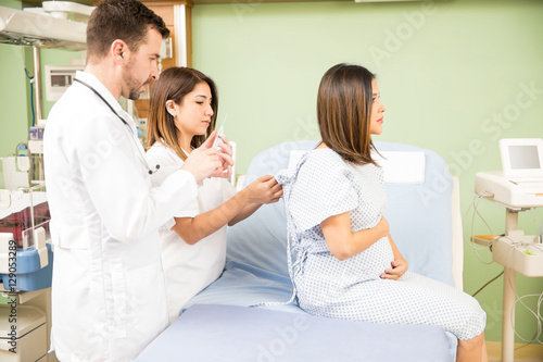 Pregnant woman receiving medical attention © AntonioDiaz
