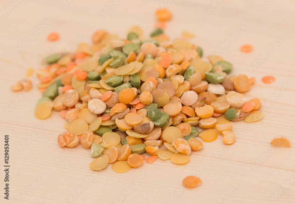 multicolored peas on a wooden background multicolored peas on a wooden background
