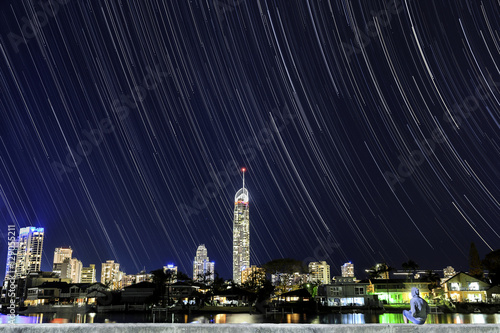 Gold Coast Surfers paradise cityscape and Q1 star trails astro with person sitting in foreground admiring the view photo