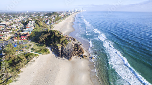 Aerial view of Miami Headland and beach as the sunrise glow hits the foreshore. Gold Coast, Australia