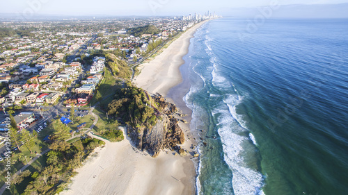 Aerial view of Miami Headland and beach as the sunrise glow hits the foreshore. Gold Coast, Australia