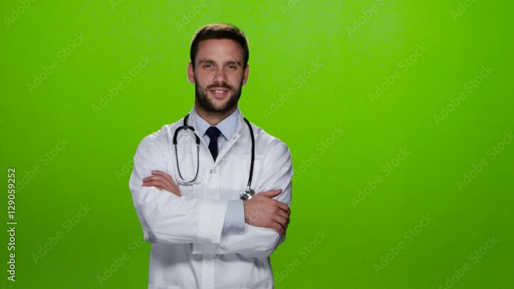 Man doctor becomes a to the camera and smiling. Studio Man doctor becomes a to the camera and smiling. Studio