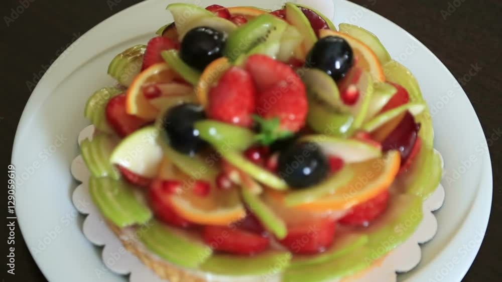 Fresh dessert fruit tart covered in assorted fruits Fresh dessert fruit tart covered in assorted fruits