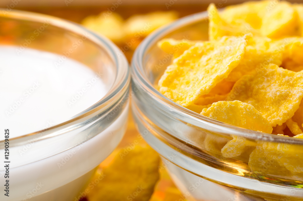Transparent cups with milk and cornflakes close-up Transparent cups with milk and cornflakes close-up
