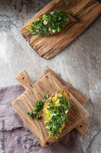 Baked sweet potatoes with kale, Cheddar cheese. Vegetarian food.