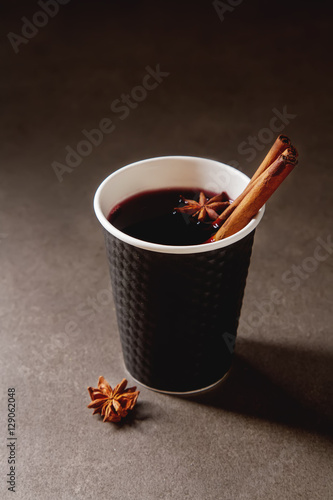 Christmas drink. mulled red wine in a paper cup with black karit photo