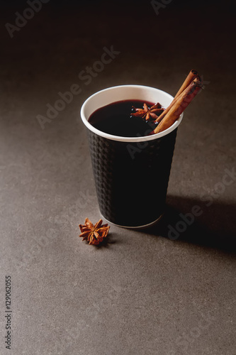 Christmas drink. mulled red wine in a paper cup with black karit photo