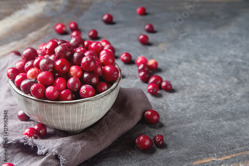 Red berries on a dark background. cranberries in a bowl.