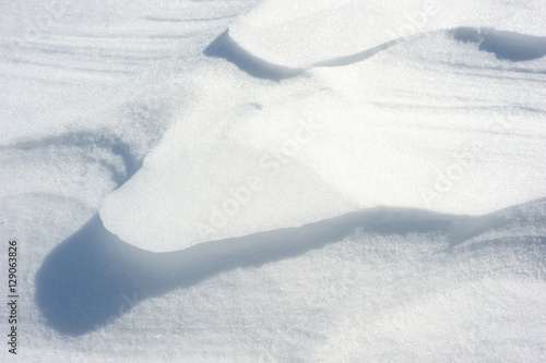 Coarse texture of the snow, accented by a sliding sun light