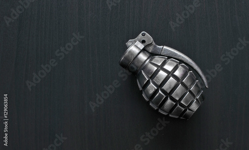 Photography Silver color grenade lighter isolated on wooden background