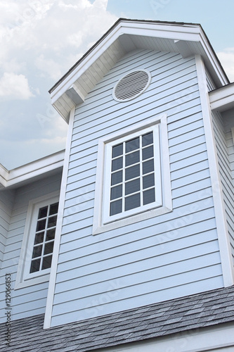 vintage house building in pastel blue color, europe style, blue sky, background