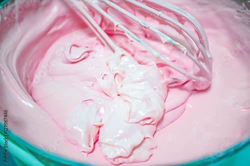 Strawberry cake,Mixing egg, flour and sugar cream in bowl with motor mixer. then baking a cake in oven. photo