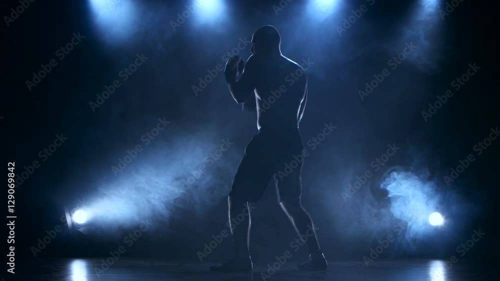 Sportsman boxer concentrates attention before the fight. Silhouette Sportsman boxer concentrates attention before the fight. Silhouette