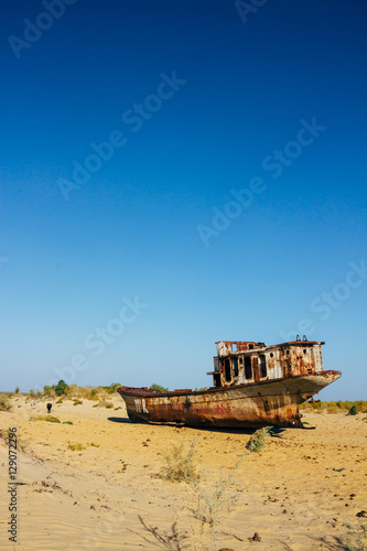 Old rustic boats and ships in a desert around Moynaq, Muynak or Moynoq - Aral sea or Aral lake - Uzbekistan, Central Asia.