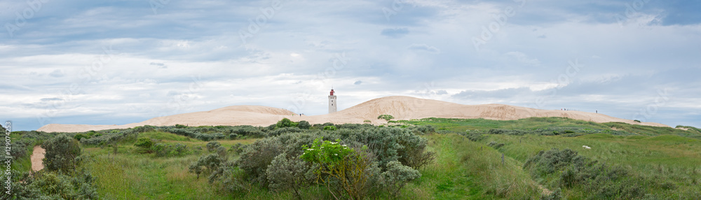 Panorama of the sandy dunes with the abandoned lighthouse of Rub