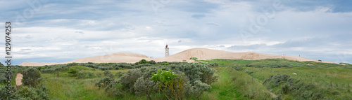 Panorama of the sandy dunes with the abandoned lighthouse of Rub