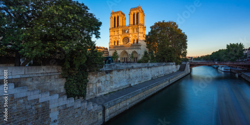 Notre Dame de Paris cathedral on Ile de La Cite at sunset with the Seine River. Summer evening in Paris, France