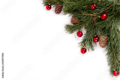 Pine branch with cones and balls on white background