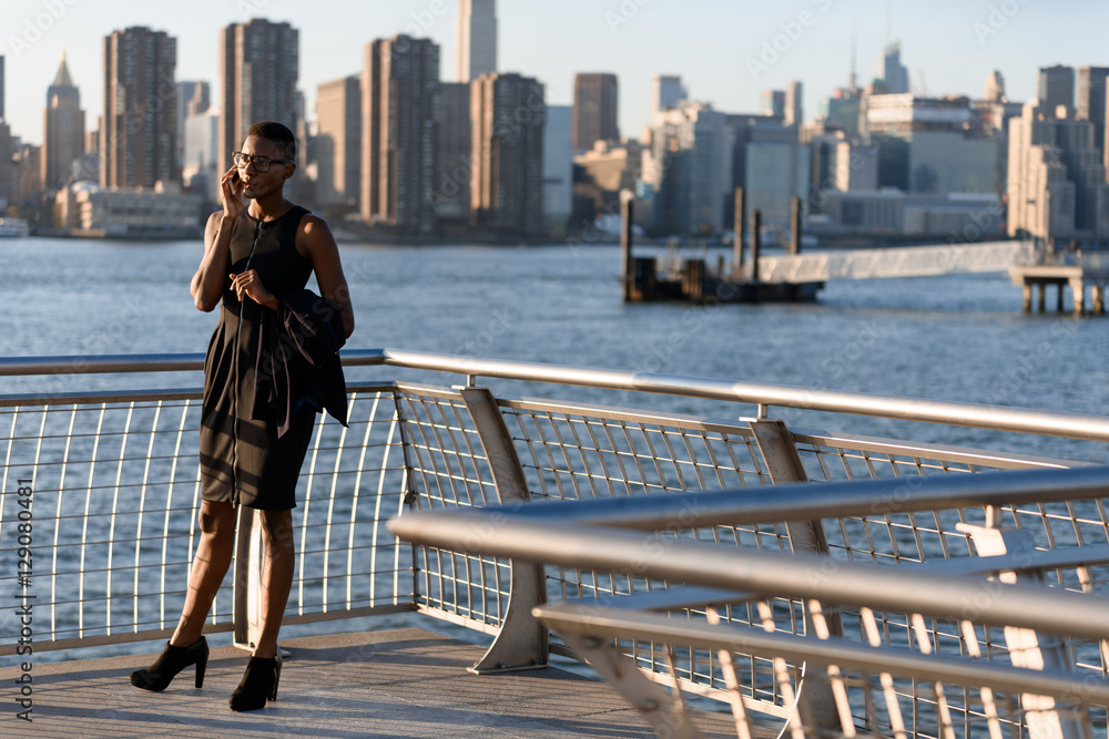 African business woman talking on the phone outdoor, New York, Manhattan, skyline view