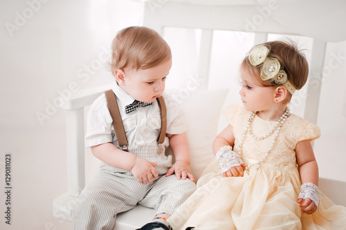 two babies wedding - boy and girl dressed as bride and groom
