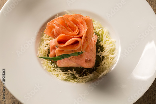 Pepper stuffed pepperloaf with pesto leg on a wooden background photo